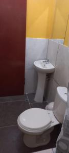 a bathroom with a toilet and a sink at La Posada in Cajamarca