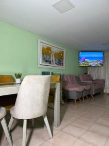 a living room with a table and a couch at Aquarium Rooms in Floridablanca