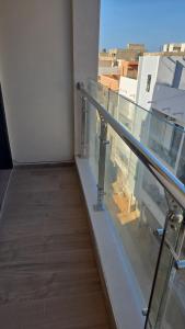 a stairway in a building with a glass railing at Ouakam Monument de la Renaissance 2 in Dakar