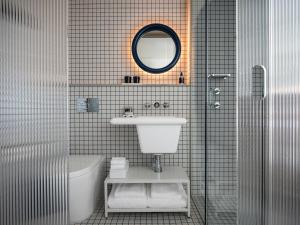 un bagno con lavandino, WC e specchio di The StandardX, Melbourne a Melbourne Altre 46 foto
