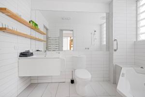 a white bathroom with a toilet and a sink at Pet Room at Moody's in Blairgowrie
