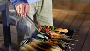 a person is cooking food on a grill at Healing Space Bungallow Bao Loc in Bảo Lộc