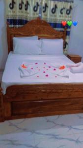 a bed with two towels and hearts on it at DALENT RESiDENCE in Brusubi