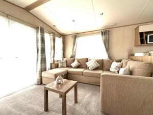 a living room with a couch and a table at The Haven in Filey +98 photos