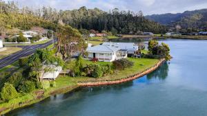 an aerial view of a house on an island in the water at Kingfisher Lodge Waterfront Retreat in Tairua
