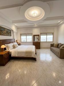 a large bedroom with a bed and a couch at Palace with Private Pool in Tamaris