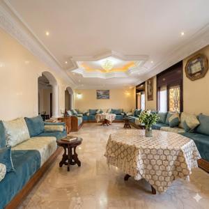a large living room with blue couches and a table at Palace with Private Pool in Tamaris +28 photos
