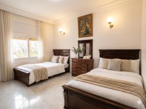a bedroom with two beds and a window at Palace with Private Pool in Tamaris