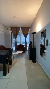a living room with a couch and a table and chairs at PB-Súper dpto Morón centro in Morón