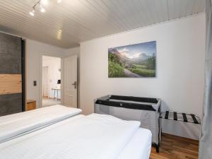 a bedroom with two beds and a painting on the wall at Kaiser Chalet Ebbs in Ebbs +29 photos