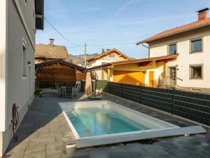 a swimming pool on a patio next to a building at Kaiser Chalet Ebbs in Ebbs