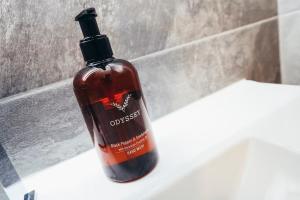 a bottle of soap sitting on top of a bathroom sink at Queensferry Collection - Residence 2 in Derby +4 photos