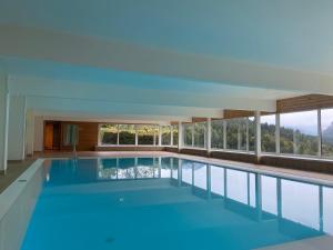 a swimming pool with a view of a building at Studio SISI in Tauplitz