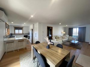 a living room and kitchen with a table and a couch at Valentine House in Hadspen