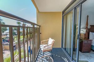 a balcony with a chair and a view of the ocean at Amazing View Ocean Front Studio Nicely Decorated in Myrtle Beach
