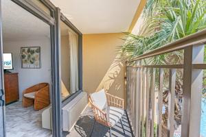 a room with a balcony with a stair case at Amazing View Ocean Front Studio Nicely Decorated in Myrtle Beach