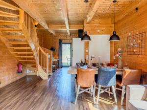 a dining room with a table and a staircase at Rattendorf 15A in Rattendorf