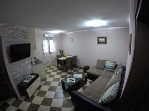 a living room with a couch and a table at Apartments Krivokapic in Kotor
