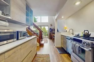 a large kitchen with a stove and a sink at Tranquil Tides Cottage in Langley