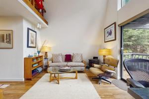 a living room with a couch and a table and chairs at Tranquil Tides Cottage in Langley