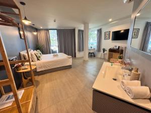 a large room with a bed and a bathroom at Phuket Muay Thai Hotel Rawai Beach in Rawai Beach +34 photos
