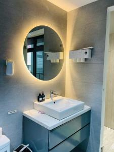a bathroom with a sink and a mirror at Win Home Huế in Hue +5 photos