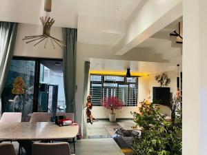 a dining room with a table and chairs at Win Home Huế in Hue