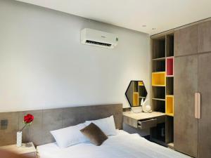 a bedroom with a bed and a desk with a computer at Win Home Huế in Hue