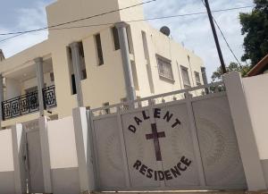 a building with a gate with a cross on it at DALENT RESiDENCE in Brusubi