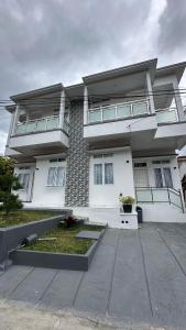 a large white house with a lot of windows at Villa Shafa Marwa in Bukittinggi