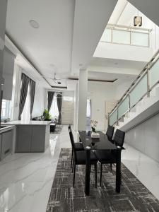 a kitchen and dining room with a table and chairs at Villa Shafa Marwa in Bukittinggi