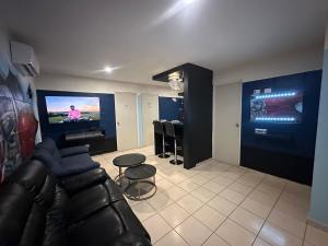 a living room with a couch and a flat screen tv at Acapulco in Mazatlán +3 photos