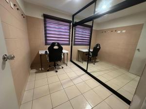a conference room with two desks and two chairs in it at Acapulco in Mazatlán