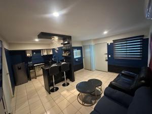 a living room with a couch and a kitchen at Acapulco in Mazatlán