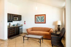 a living room with a couch and a table at Villa Costera 904 | Island Escapade | Culebra in Culebra