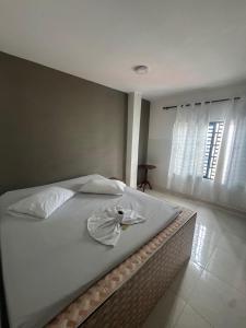 a bed with two towels on it in a bedroom at HOSPEDAJE CASANOVA FlORIDA VALLE in Florida