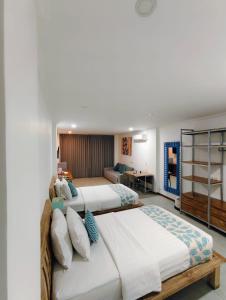 two beds in a hotel room at Triple 888 Suites in Labuan Bajo