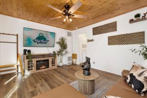 a living room with a ceiling fan and a fireplace at Shiloh Woods Cabin Walk to Lake & Village Fireplace Cozy Retreat in Big Bear Lake