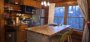 a kitchen with a wooden counter top and a sink at Timber Wood, Log Cabin, Private Hot Tub, WiFi, Fireplace in Sevierville