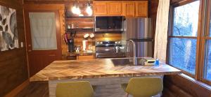 a kitchen with a wooden counter top with a sink at Timber Wood, Log Cabin, Private Hot Tub, WiFi, Fireplace in Sevierville
