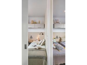 a little girl laying on a bed in a room at Mobile home Keiheuvel 6p in Balen +16 photos