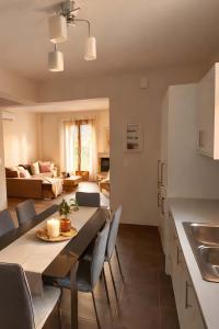 a kitchen and living room with a table and chairs at Epidavros View Villas in Ancient Epidauros