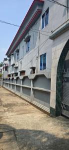 a building with balconies on the side of it at Shanti villa in Kadipur