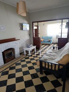 a living room with a fireplace and a couch at Sierras & Urbana in Tandil
