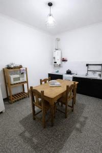 a kitchen with a wooden table in a room at Sierras & Urbana in Tandil