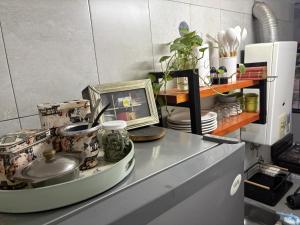 a kitchen counter with dishes and a picture on it at Jerarquizado M Rentals in Santiago del Estero