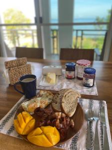 a table with a plate of breakfast food on a table at GJ House in Esperanza, Poro, Camotes in Mactan