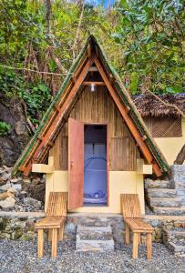 a small house with two chairs and a door at L'Astrolabe - Private Beach in Baras +32 photos