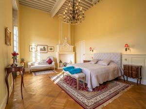 a bedroom with a bed and a chandelier at French Estate with Pool & Sauna in Damiatte +19 photos