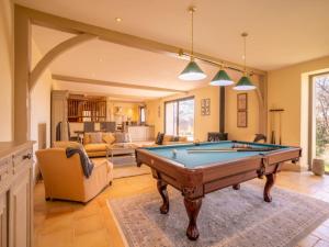 a living room with a pool table in it at French Villa with Pool & Games Room in Damiatte